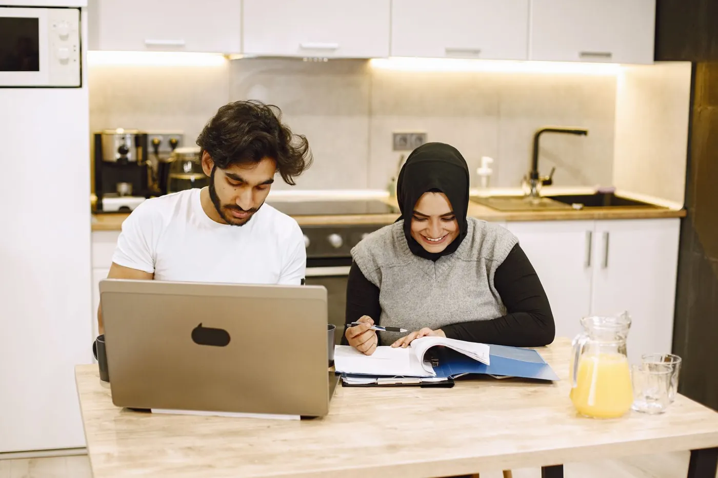Illustrative photograph of an adult using a laptop at home