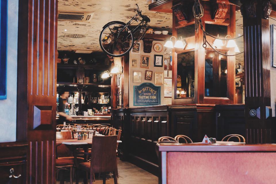 A busy restaurant kitchen pass and dining room during service — the daily cash demands of a hospitality business that working capital is built to smooth.