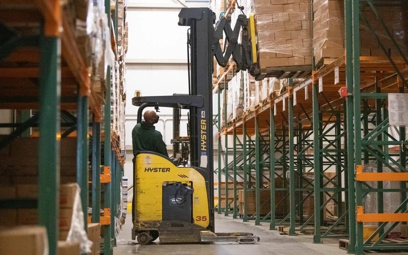 A wholesale distribution warehouse stacked with palletised stock — the inventory a UK distributor carries between buying in bulk and shipping out to trade buyers