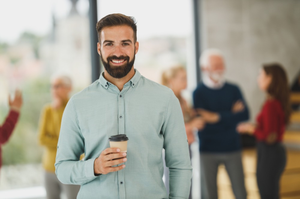 A friendly lending adviser at his desk — a real person reviews every Credicorp application.